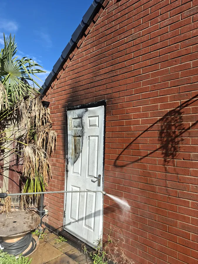 Soot removal pressure washing on gable wall